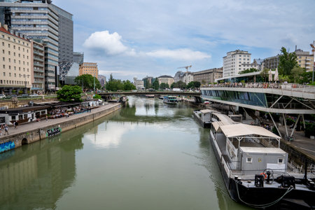 Vienna, AT - June 9, 2023 View from the MarienbrÃ¼cke bridge of the Wolfgang-Schmitz-Promenade, Schiffsstation Wien / Wien-Bratislava ferry and the Restaurant Motto am Fluss on the Danube canal.のeditorial素材