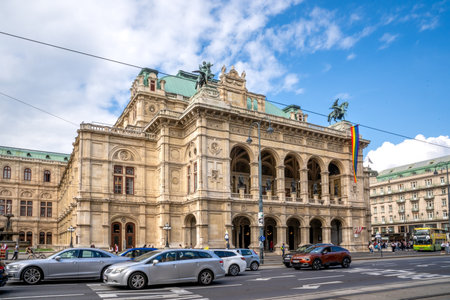 Vienna, AT â June 9, 2023 Wide three quarter view of tourists walking by the historic 1,709-seat Renaissance Revival Vienna Operahouse. The first major building on the Vienna Ring Road.のeditorial素材