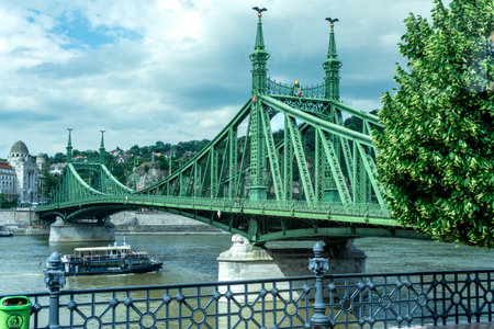 Budapest, HU â June 11, 2023 View of the SzabadsÃ¡g hÃ­d (Liberty Bridge or Freedom Bridge) spanning the Danube River in Budapest. A cantilever truss bridge with a suspended middle span.のeditorial素材