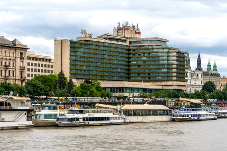 Budapest, HU â June 11, 2023 Glass and concrete T-shaped Budapest Marriott Hotel, a dominant feature of the Danube riverside in Pest and in the center of Budapest. Built in 1969 by JÃ³zsef Finta.のeditorial素材