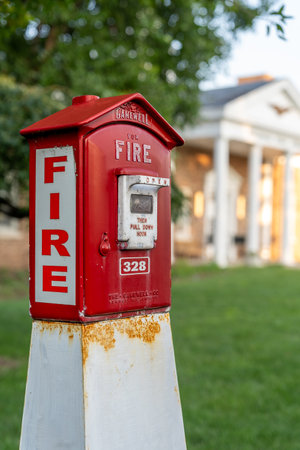 Ridgewood, NJ - USA â Aug 2, 2023 Horitzontal view of a red and white callbox,  also know as a fire alarm box or fire alarm pull box. The device is used for notifying a fire department of a fire.のeditorial素材