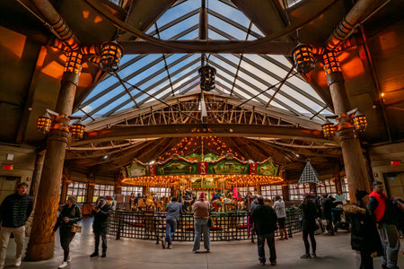 Bear Mountain, NY - US - Dec 30, 2023 Interior view of guests enjoying the Merry-Go-Round at Bear Mountain State Park. The Carousel features scenes of the park and hand carved seat of native animals.のeditorial素材