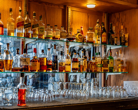 Bear Mountain, NY - US - Dec 30, 2023 Horizontal closeup of the selves of liquor, glassware and backbar of the lounge at Bear Mountain Innâs 1915 Restaurant. Located in Bear Mountain State Park.のeditorial素材