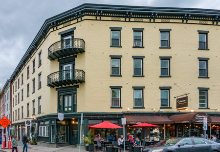 Kingston, NY - US - May 11, 2024 The yellow four story brick building on the corner of Broadway and West Strand Street is located in the heart of Kingston's Historic Rondout Districtのeditorial素材