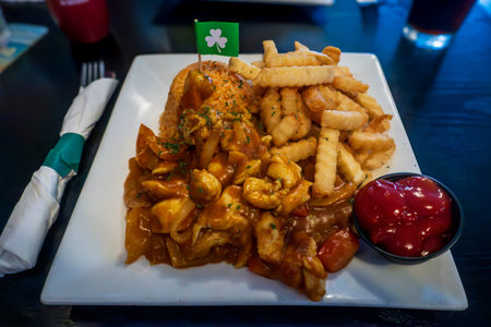 Savory chicken curry with tender chunks of meat, bell peppers, and onions in a rich sauce, served...
