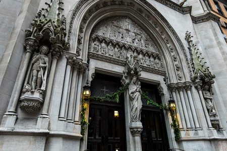 New York, NY â US â Dec 13, 2025 An ornate, Gothic Revival entrance to the Church of Saint Mary the Virgin in Times Square, featuring detailed stone carvings and statues.のeditorial素材
