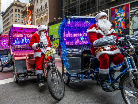 New York, NY â US â Dec 13, 2025.Â Two Santas on light-up pedicabs on Fifth Avenue in New York City.Â A festive, holiday scene in Manhattan with "Welcome to New York" signs.のeditorial素材