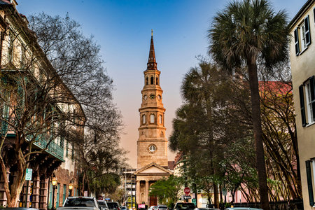 Charleston, SC - US - Mar 27, 2026 A view down Church Street to the historic St. Philip's Episcopal Church in Charleston, South Carolina, featuring its iconic steeple against a warm sky.