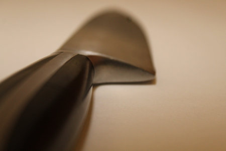 chef's knife with selective focus against a white backdrop
