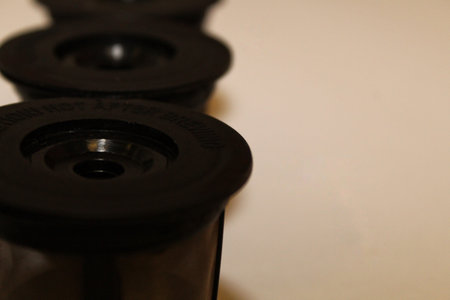a row of kcup containers on left side with selective focus on the first unit