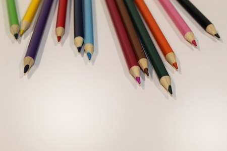 Colored Pencils Scattered across the top of the frameの写真素材