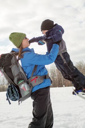 Mom and Young Boy Swinging With Snowshoes7の写真素材