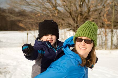 Young Woman and Son Hugging on Winter Trail6の写真素材