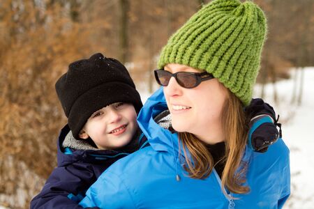Young Woman and Son Hugging on Winter Trail8の写真素材