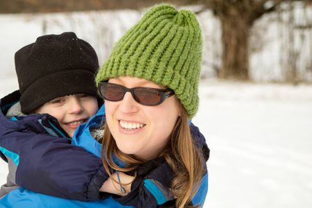 Young Woman and Son Hugging on Winter Trail11の写真素材