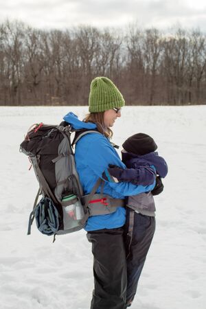 Hiking Mom and Young Boy Hugging In Fieldの写真素材