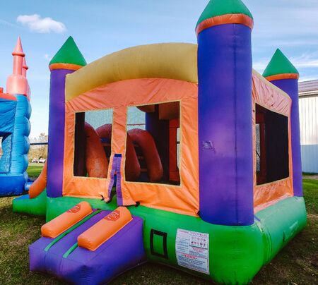 Colorful square children's bounce house with oranges, blues, greens and yellowsの写真素材