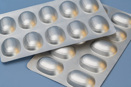 Vitamins tablets supplements in blister packs on Blue background