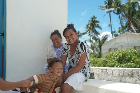 Aitutaki, Cook Islands, November 9 2010, Three island children present happy care free image.のeditorial素材