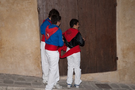 Gubbio, Italy, May 15 2011, young men assis each other in preparations for their part in the Festa Dei Ceri.のeditorial素材