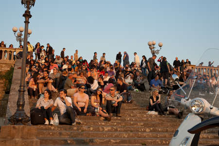 Florence, Italy - April 21 2011: Crowd gathers each night as the sun goes down  in the romantic setting, on the steps of the Michelangelo car park.のeditorial素材