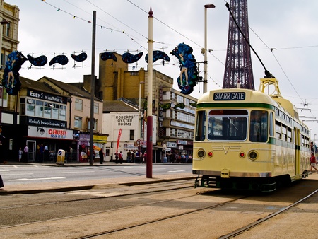 BLACKPOOL, ENGLAND - Starr Gate tram runs along the Promenade, Blackpool Tower in background on June 28, 2009. Trams date back to 1885 and are one of the oldest electric tramways in the world.のeditorial素材