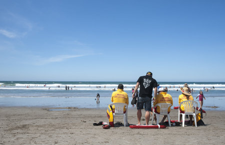 Tauranga, New Zealand, December 29, 2012; lifeguards sit watching swimmers knowing of the dangerous...