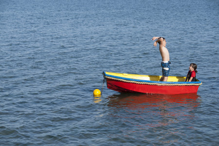 TAURANGA, NEW ZEALAND - JANUARY 9, 2013: As children do everywhere, two here play around in moored...