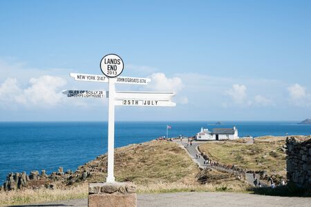 Lands End, England - July 25, 2013  the famous direction sign at the point at Lands Endd, the western-most part of Englandのeditorial素材