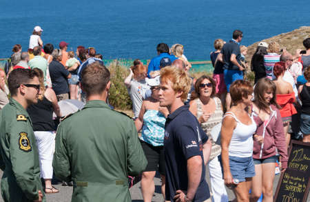 Lands End, England - July 25, 2013  Crowd assemble to watch helicopter rescue exercise at the tourist attraction のeditorial素材