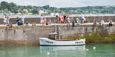 Padstow, England; July 30, 2013  People fishing from the Padstow harbour breakwater  Crab fishing is a popular pastime for holidaymakers in Padstow のeditorial素材