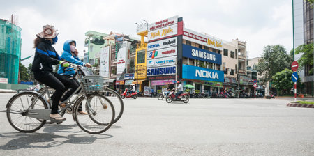Can Tho, Vietnam - October 15, 2013  street scene with internations brands signs on buildings across...