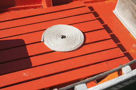 Coiled rope on boat floor.の写真素材