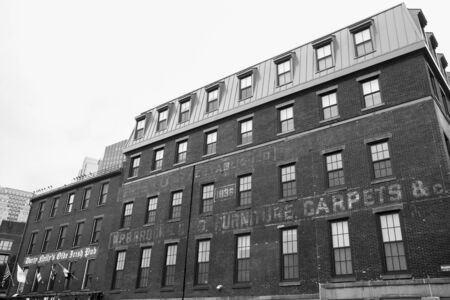 BOSTON, USA - OCTOBER 14, 2014; Old Boston Buildings & Street Scene with faded signage on brick exterior and an out of character rooftop additionのeditorial素材