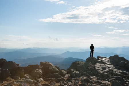 Man stands in silhouette on top of Mount Washington, looking out at view.のeditorial素材