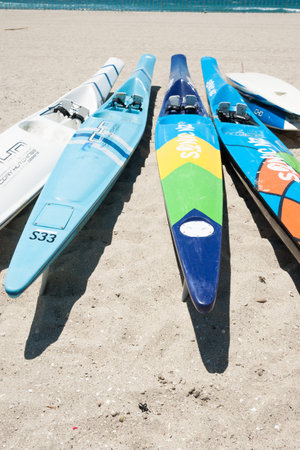 MOUNT MAUNGANUI, NEW ZEALAND-JANUARY 22, 2015; Surf skis on beach ready for event with tower apartments in background at Mount Maunganui, New Zealand. Surf championships are being held here.のeditorial素材
