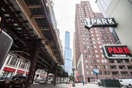 Chicago, Illinois, USA, August 27 2015 -  buildings towering overhead, overground railway, retro style carpark signs and Trump Tower in distance. Illinois, USAのeditorial素材