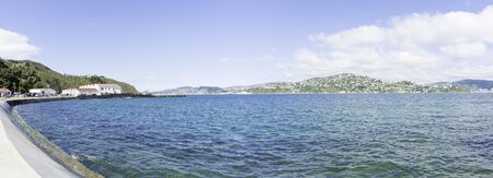 View across Evans Bay from Shelly Beach Road with old Miramar sheds Wellington. People blurred and unrecognizable.の写真素材