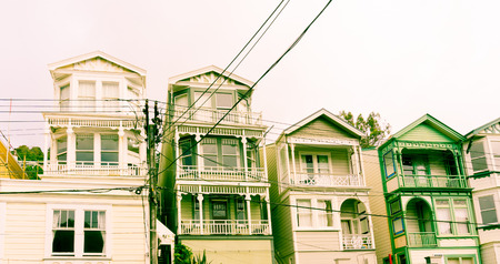Wellington suburban Victorian architecture old wooden multi-storied terrace homes with old power lines in reto style green huesの写真素材