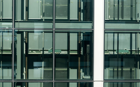 Industrial abstract window with mechanical fittings viewed from near building grungy window.