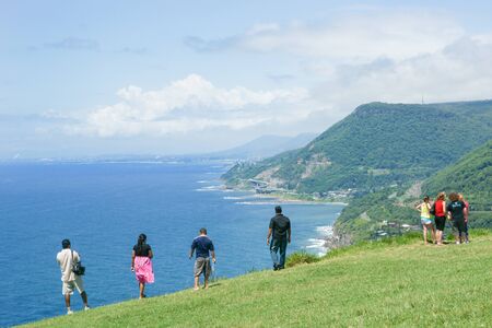 New South Wales, Australia - January 21, 2011; Tourists stop to take in view and the distant Sea Cliff Bridge which  is a highlight along Grand Pacific Drive on New South Wales coastal route.のeditorial素材