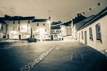 Cawsand England - July 23, 2013: Long exposure split tone image night time in old English coastal village old buildings and shops around town centerのeditorial素材