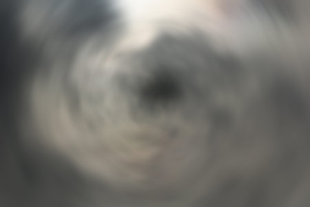 Heavy overhead dark stormy cloud formations blowing across sky.の写真素材