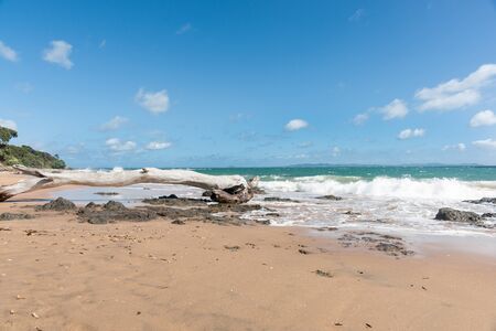 Blue sky above scenic red sand and blue sea of Cable Bay Northland New Zealand.の写真素材