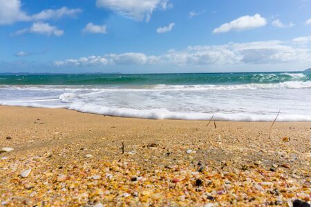 Blue sky above scenic red sand and blue sea of Cable Bay Northland New Zealand.の写真素材