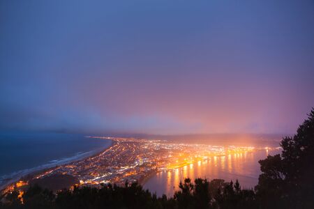 Mount Maunganui township lit by night lights from top of Mount Maunganui.の写真素材