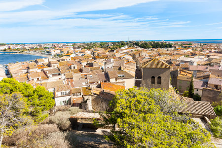 View of typical Mediterranean rooftops with terracotta tiles in coastal town Gruissan, France.の写真素材