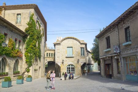 Carcassonne, France - October 21, 2016; Tourists in street bordered by traditional style stone buildings and shops in historic city of Carcassonne, Franceのeditorial素材