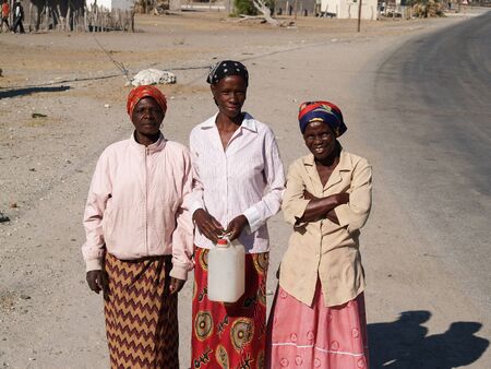 Gweta, Botswana - August 28, 2007; Three women on street of small village and people of Gweta on the Makgadigadi Pans in Botswanaのeditorial素材