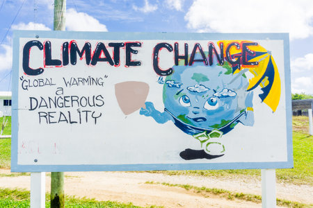 Alofi, Niue - May 31, 2017; Humour with serious message, Climate change sign with warning message near Hannah International Airport at Niue in South Pacific.のeditorial素材
